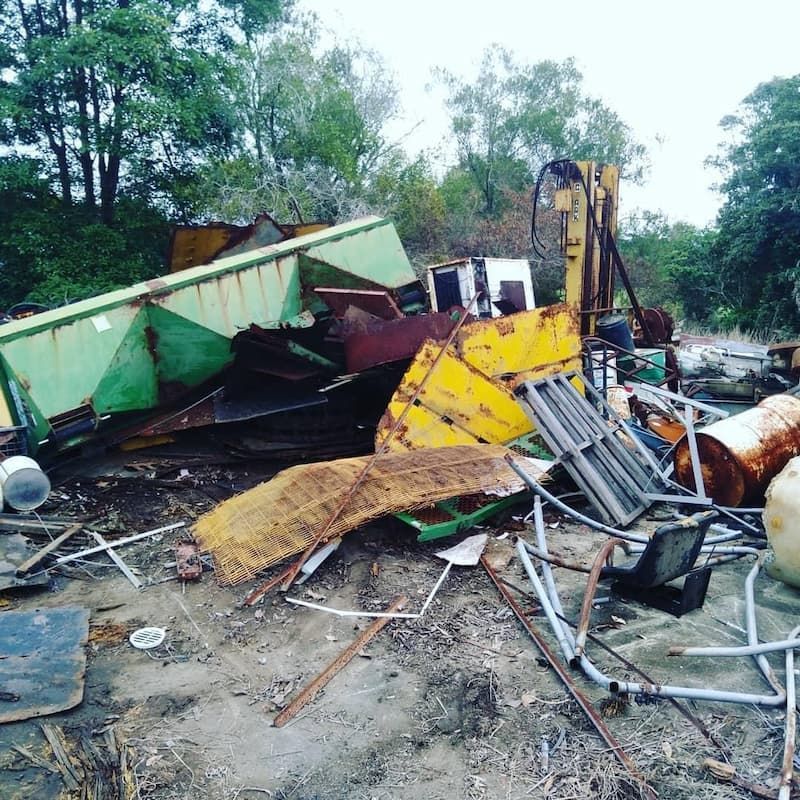 A Pile Of Scrap Metal Is Sitting On The Ground In A Field — East Coast Metal Recycling In Tugun, QLD