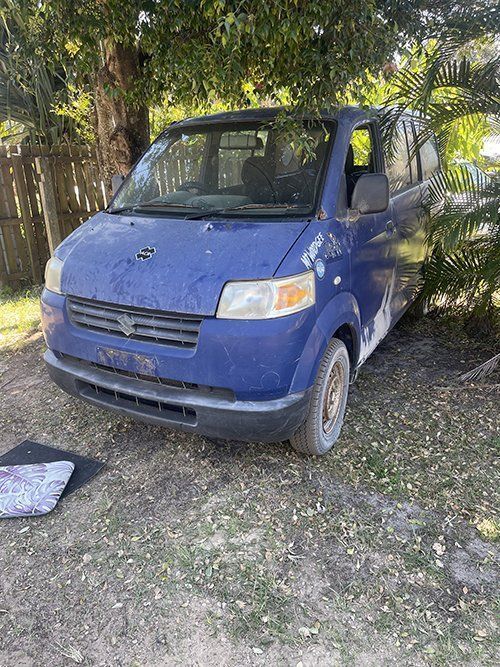blue van parked next to a tree — East Coast Metal Recycling In Tugun, QLD