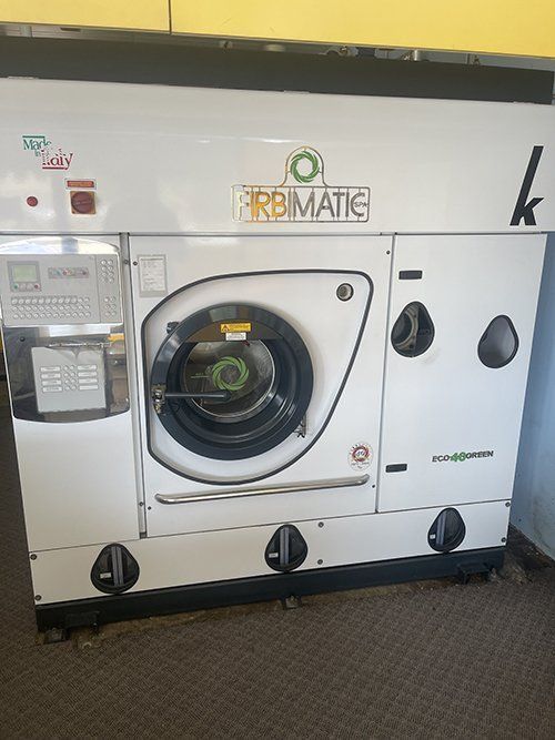 A White Washing Machine Is Sitting On A Carpet In A Room — East Coast Metal Recycling In Southport, QLD