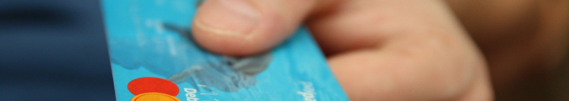 A person is holding a credit card in their hand.