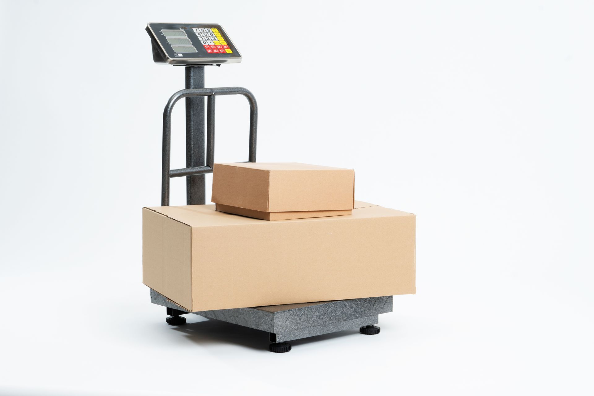 Industrial scale for weighing parcels for shipping with adhesive tape for packaging.
