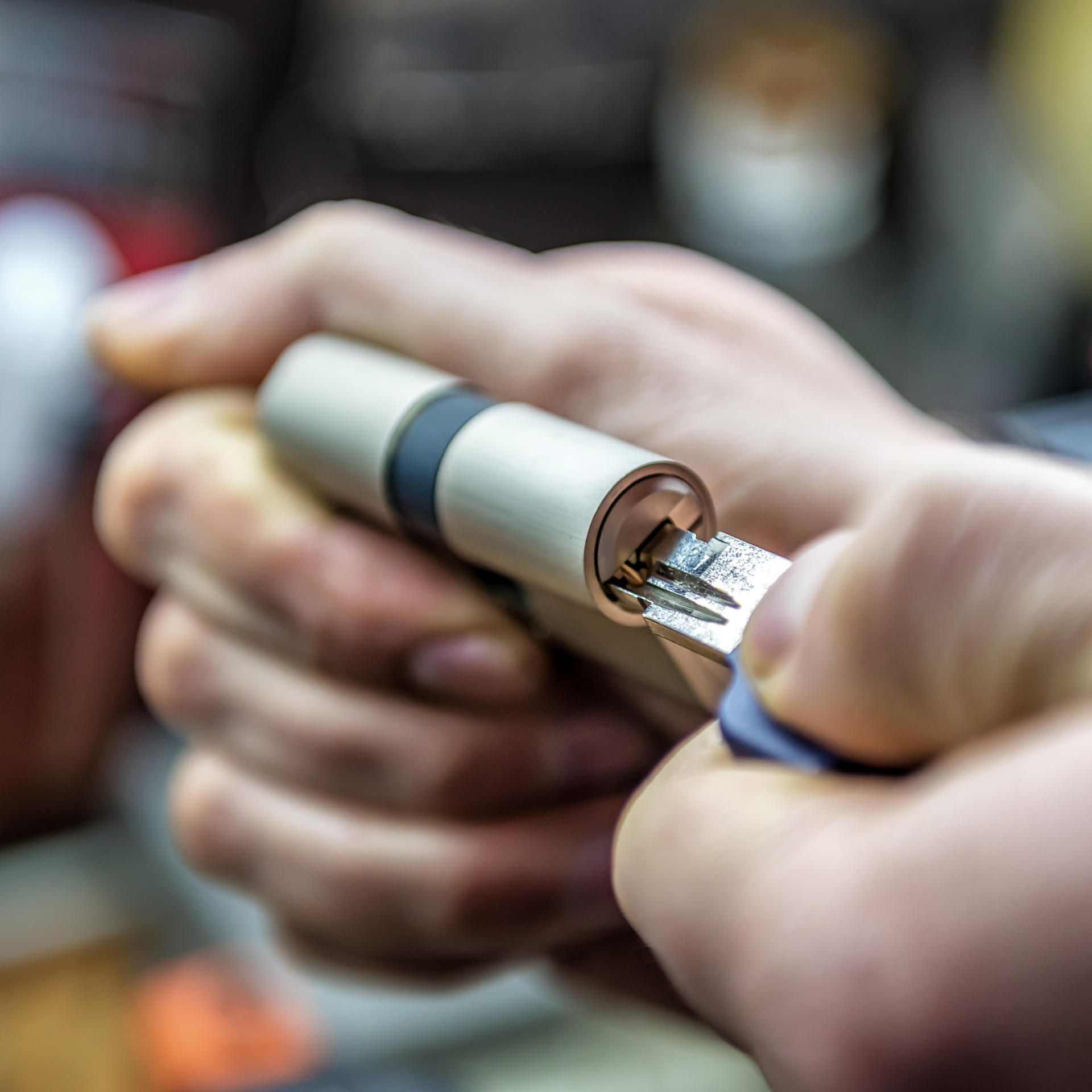 Locksmith putting key into barrel