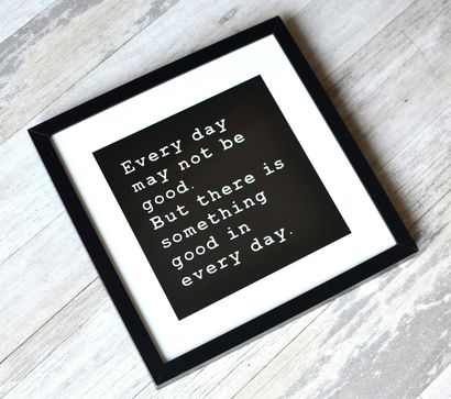 Black framed print with white text on a black background: 