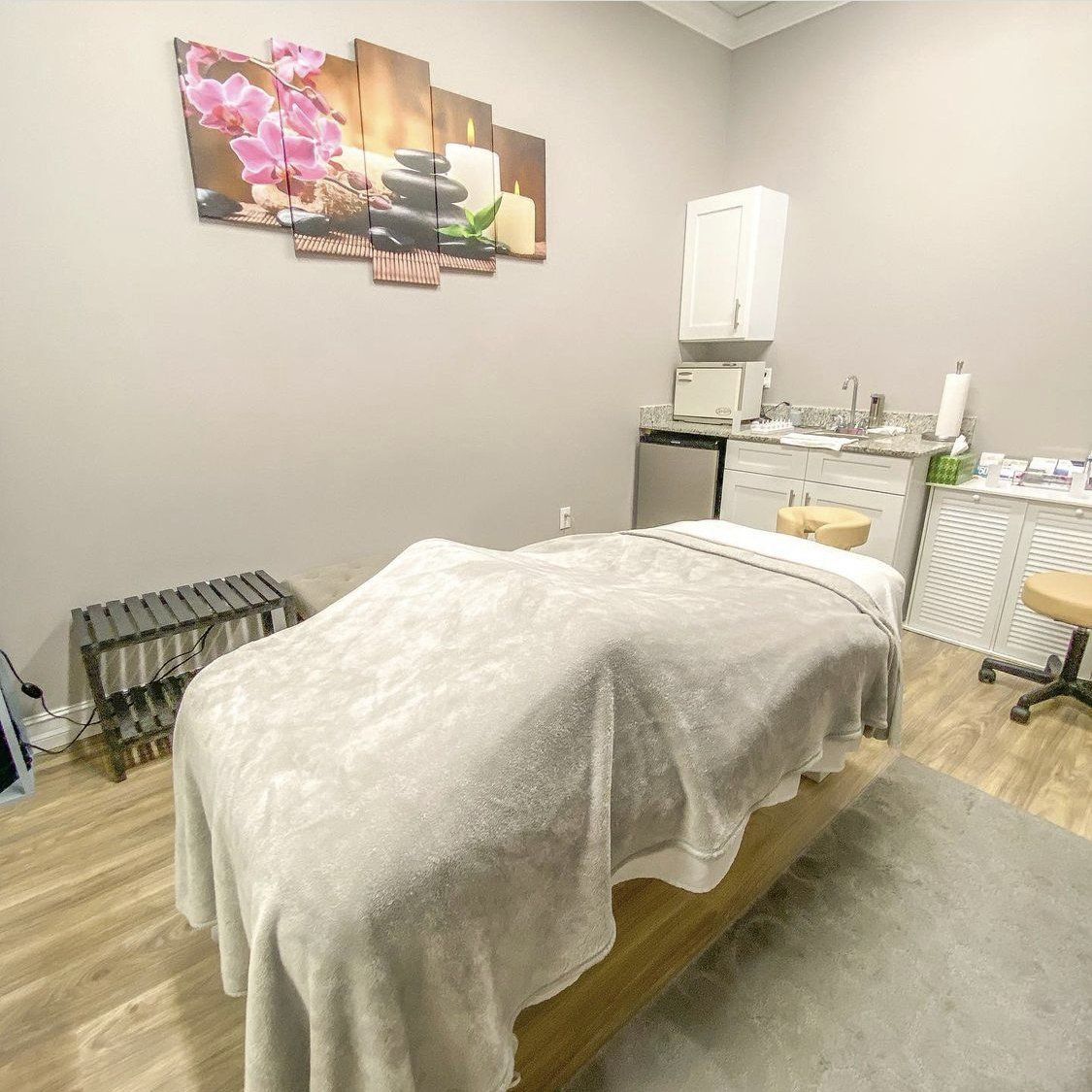 There is a massage table in the middle of the room.