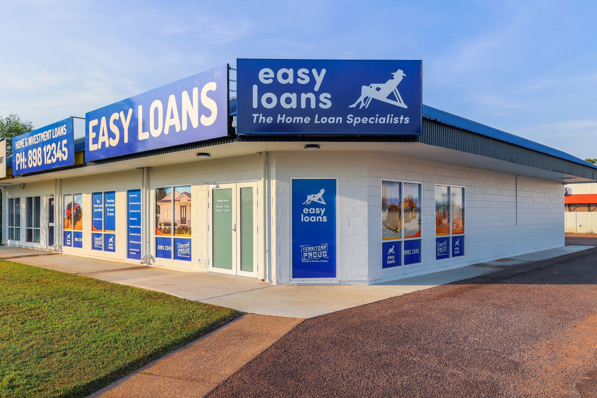 Exterior of Easy Loans office building, white with blue signage. Blue banners and window displays.