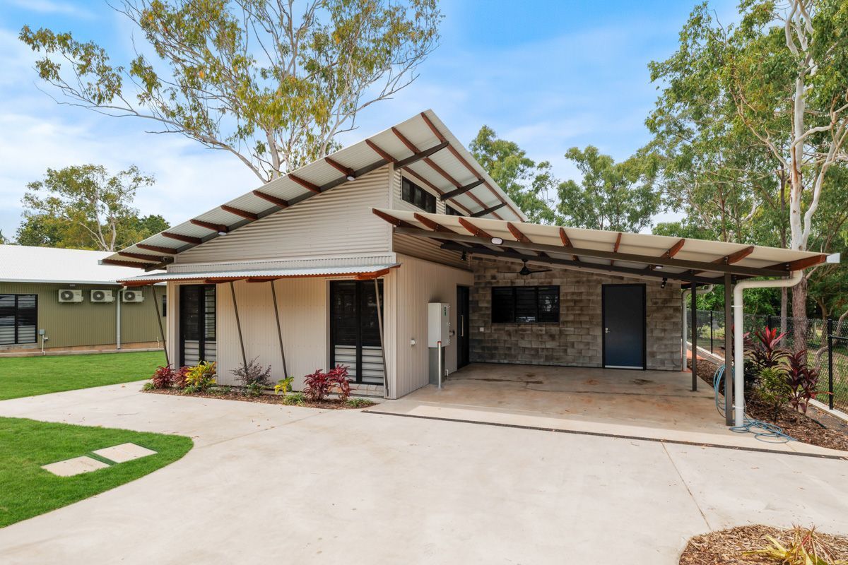 Modern house with a carport and a sloping corrugated iron roof.