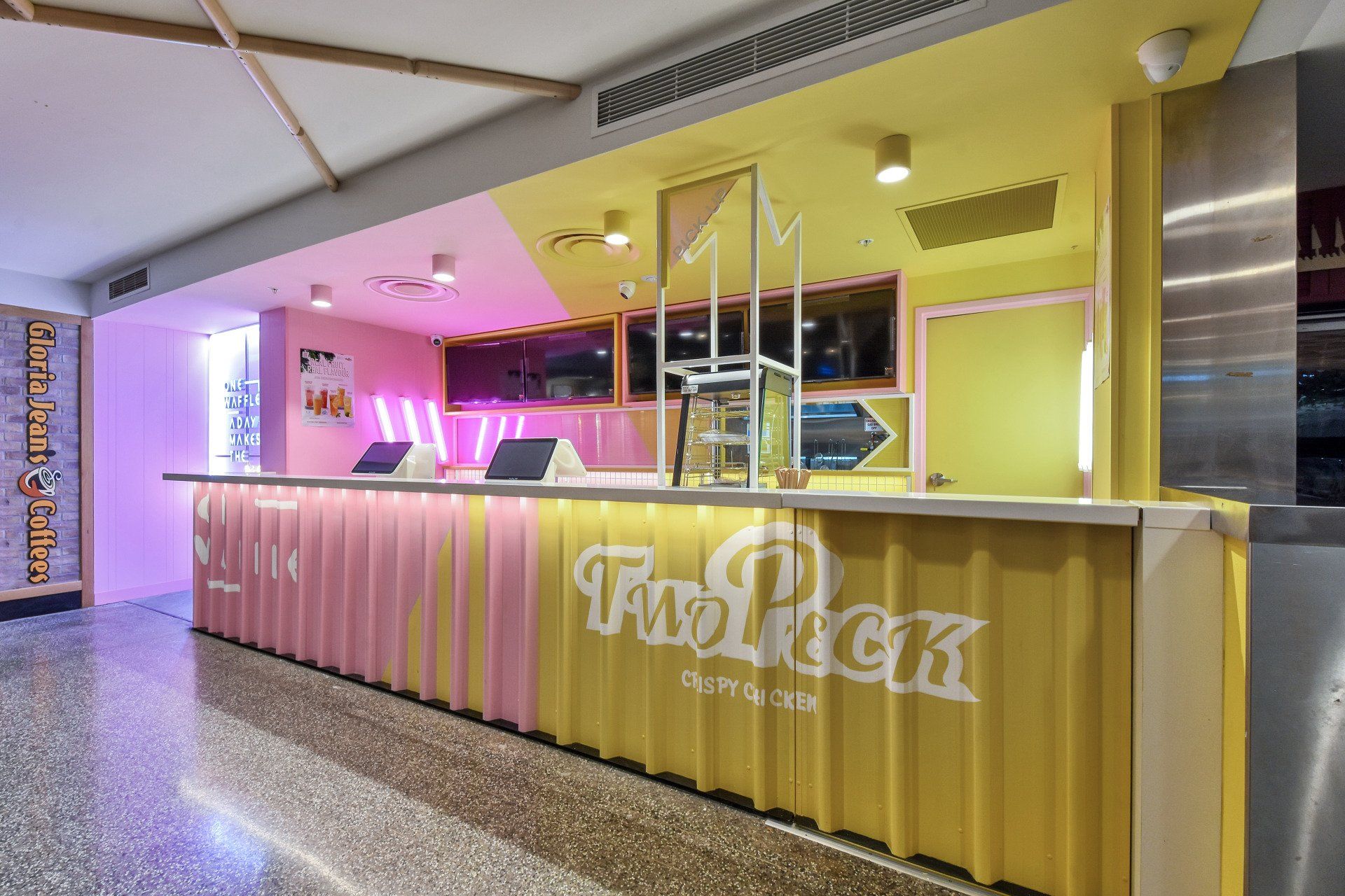 Restaurant counter with pink and yellow paneling, 