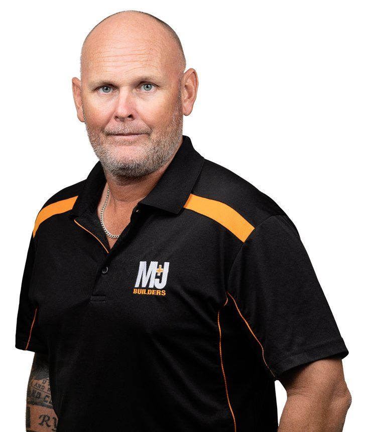 Man in black polo shirt with orange accents; smiling.