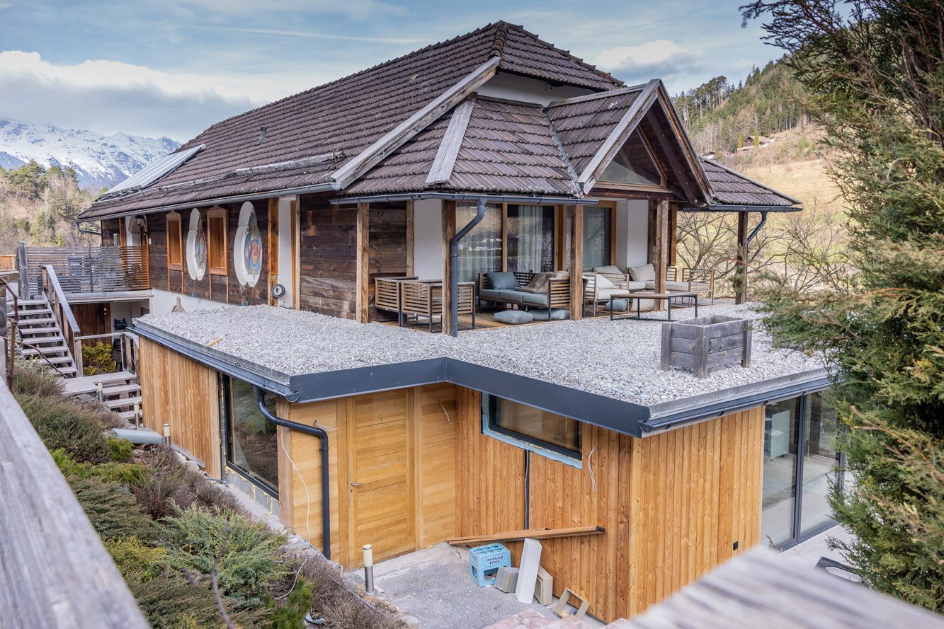 Modern wooden chalet-style house with balcony and mountain view
