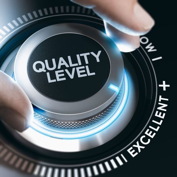 a person is pressing a button that says quality level