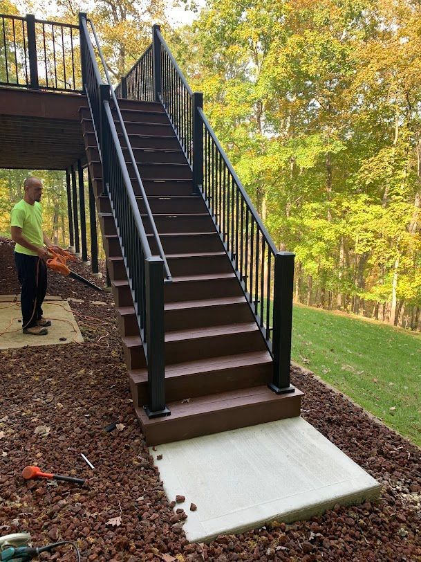 A man is standing next to a set of stairs.