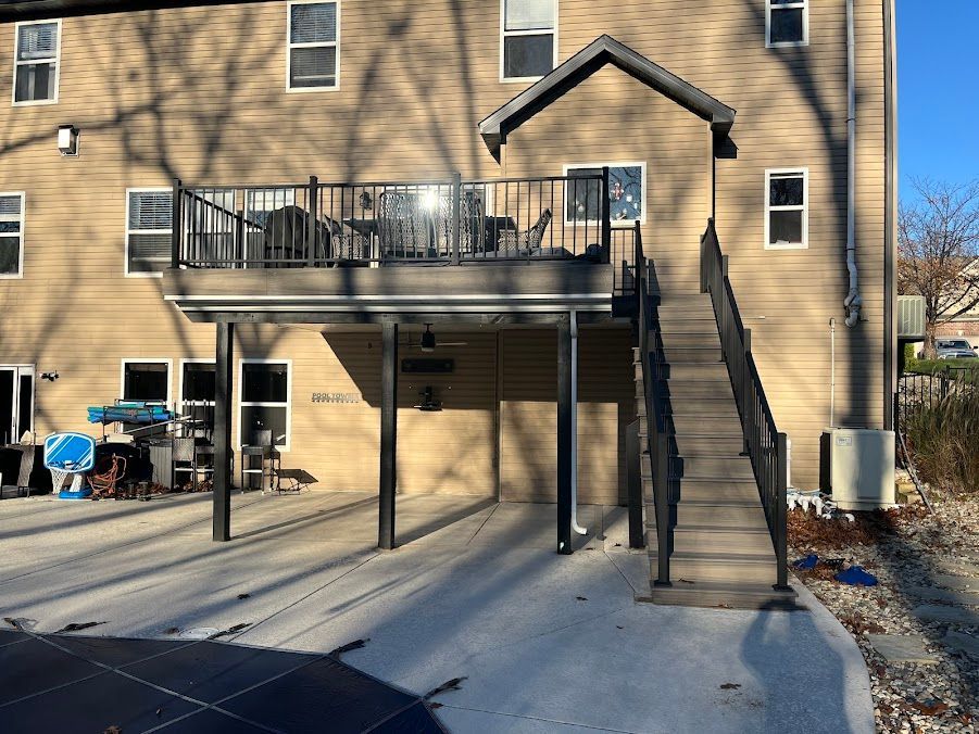 A house with a large deck and stairs leading up to it