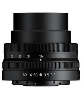 A close up of a Nikkor camera lens on a white background, viewed from the front, facing up.