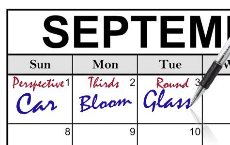 A pen is writing different sets of words in boxes on a calendar for September