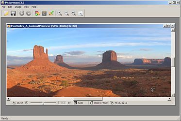 A computer screen displays the Picturenaut 3 software interface, complete with top bar menu. The image area shows a picture of a desert landscape with mountains in the background.