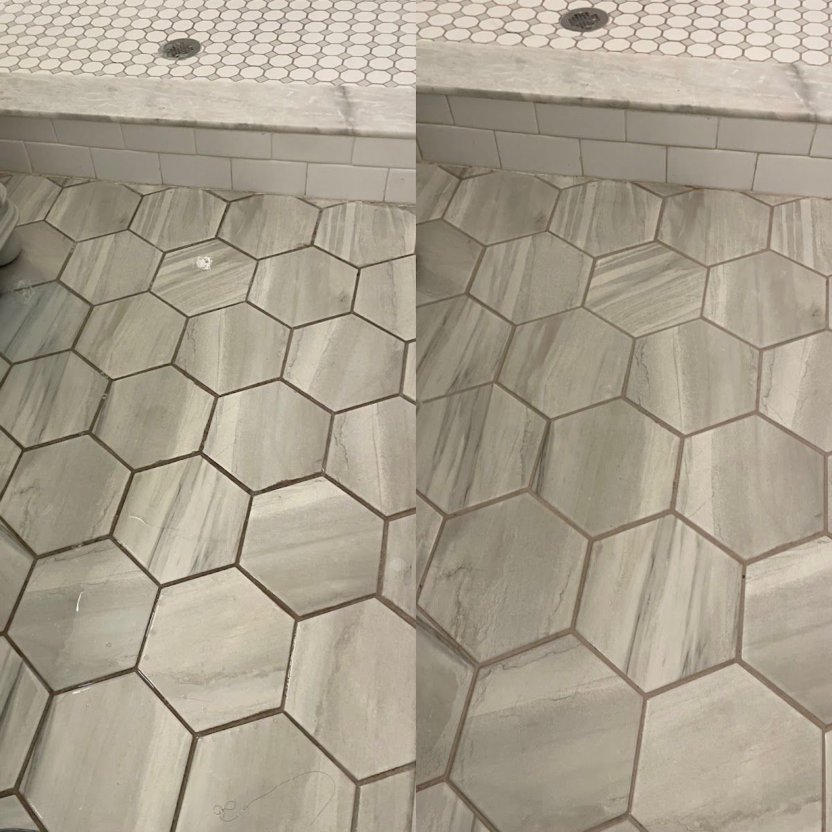 Shower floor with hexagonal gray tiles and dark grout, adjacent to a white tiled shower threshold.