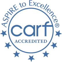 CARF accredited logo with blue circle and stars, reading “Aspire to Excellence” and “carf accredited”