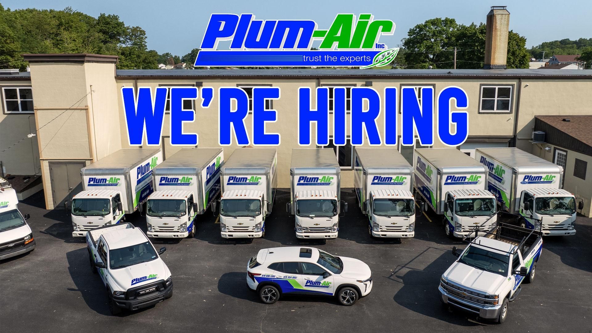 Plum Air fleet with “WE’RE HIRING” sign in front of service trucks and vans