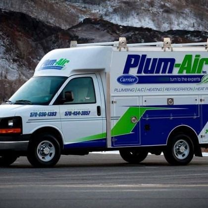 Plum-Air service van parked on a road, white and blue with green accents.