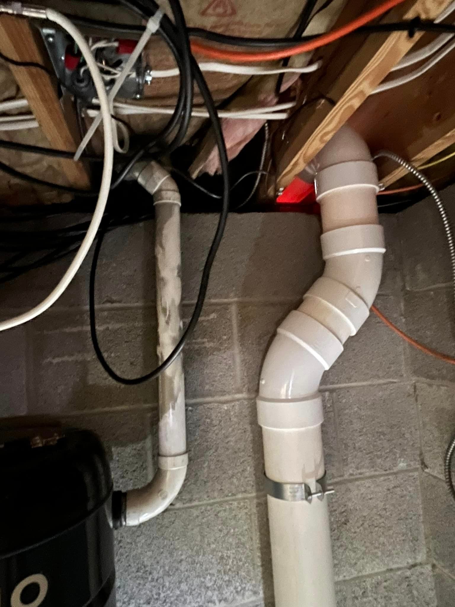 A bunch of pipes are connected to each other in a basement.
