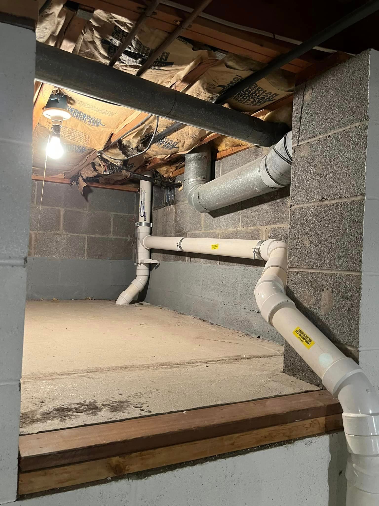 A basement with a lot of pipes coming out of it.