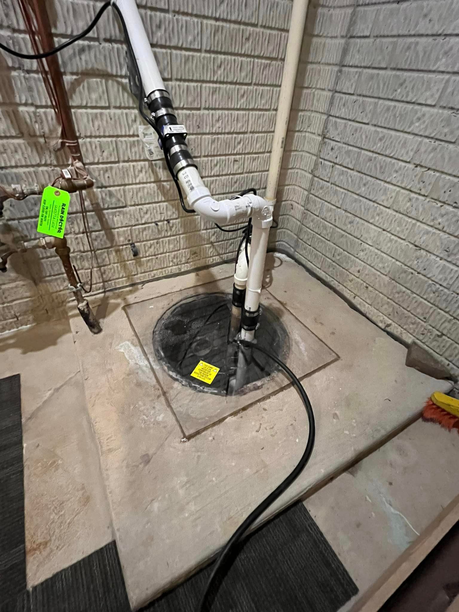 A sump pump is being installed in a basement.