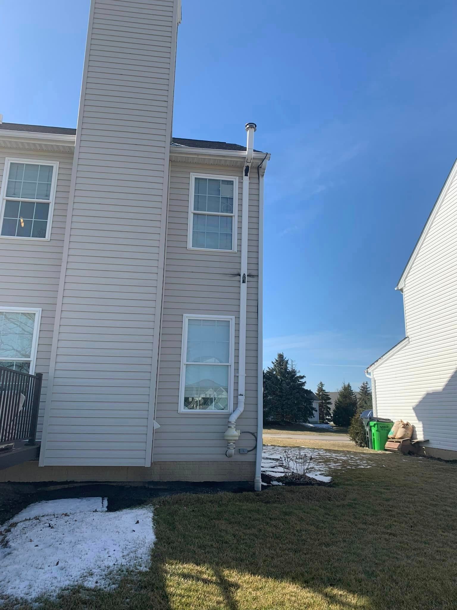 A house with a chimney on the side of it.