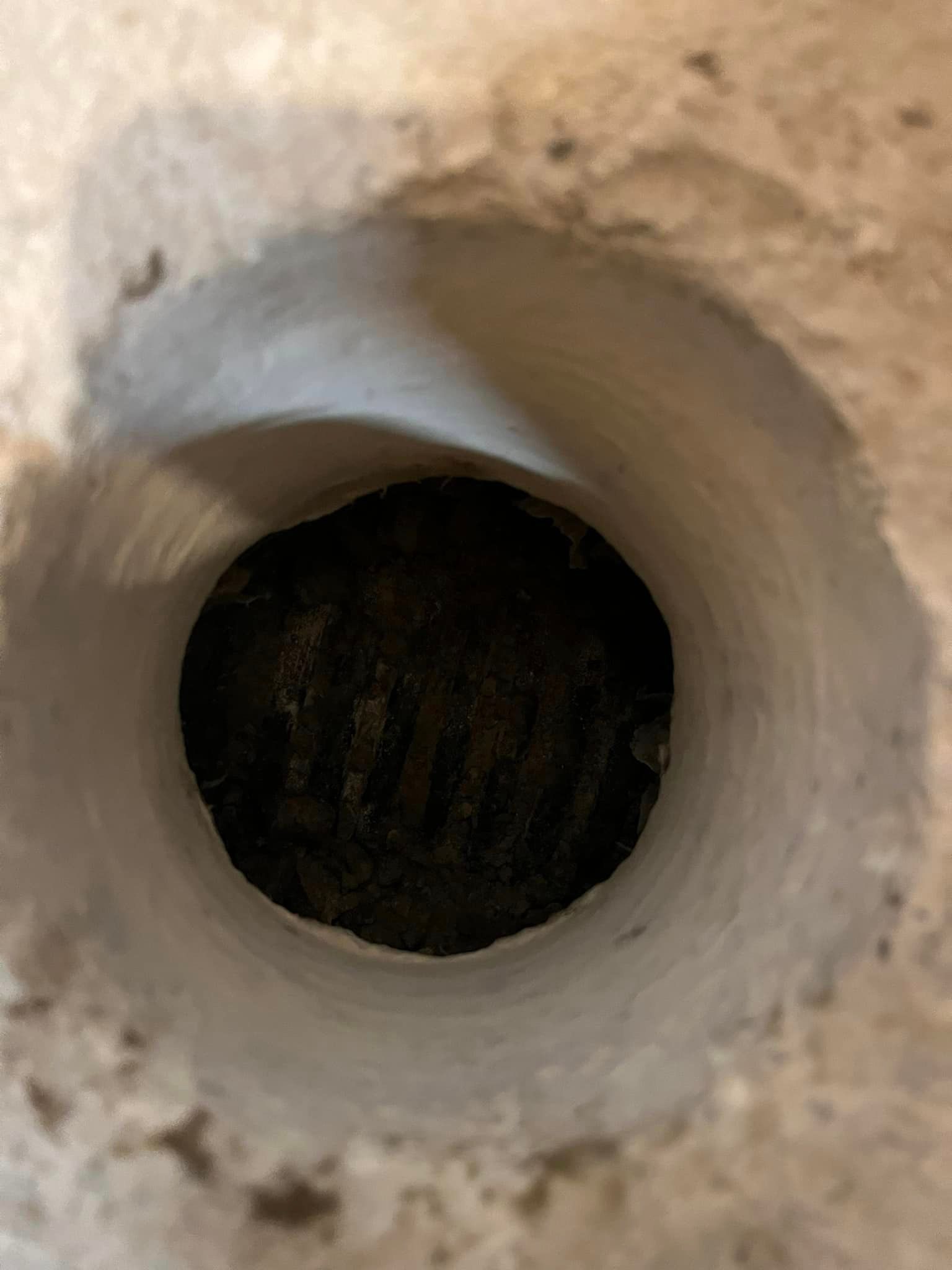 A close up of a hole in a concrete wall.