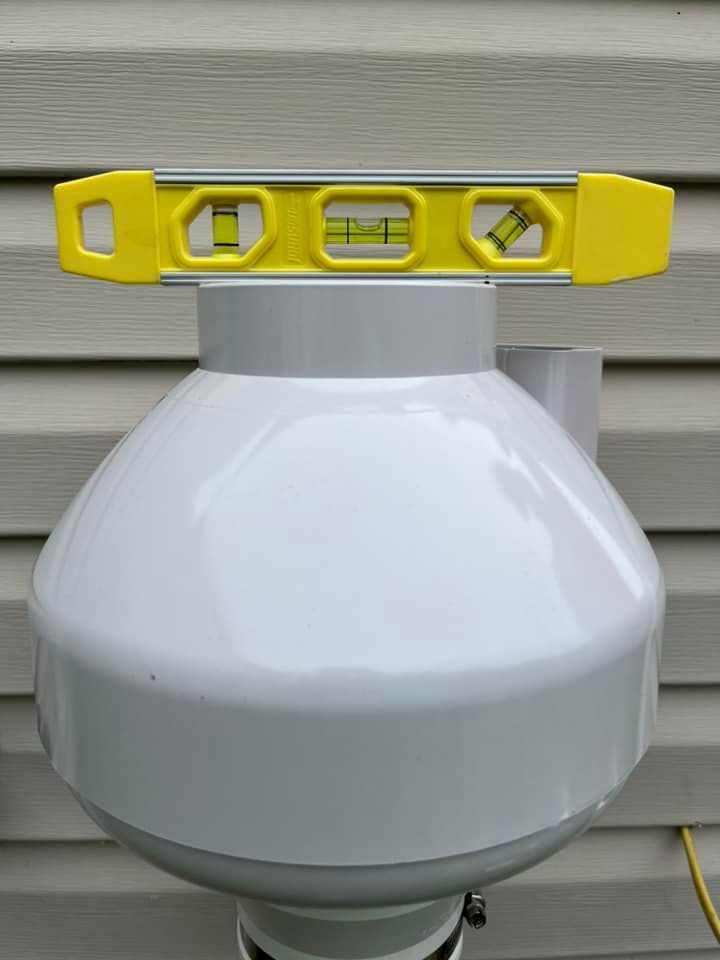 A yellow level is sitting on top of a white object.
