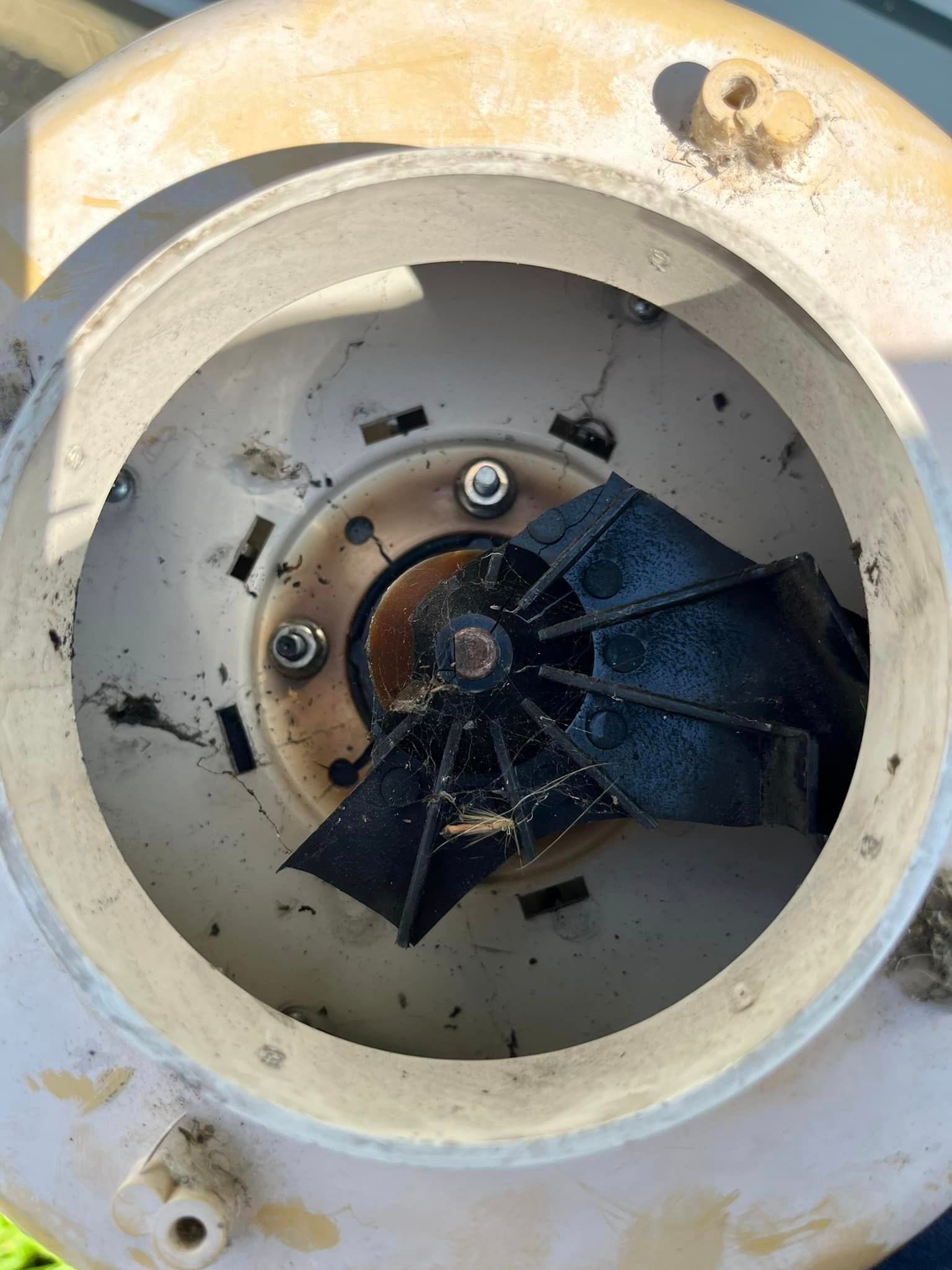 A close up of the inside of a machine with a fan in it.