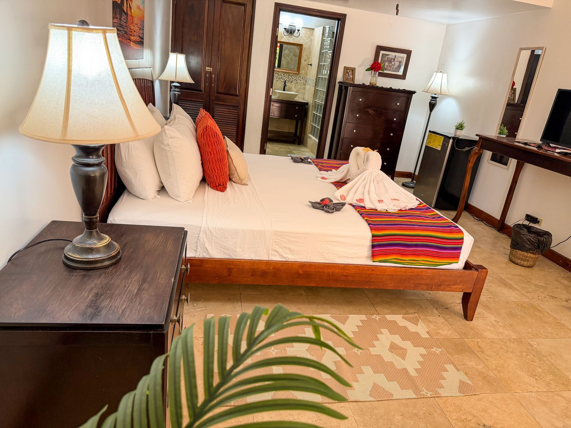 Comfortable king-size bed in a guest room at Caribbean Shores B&B Hopkins Belize