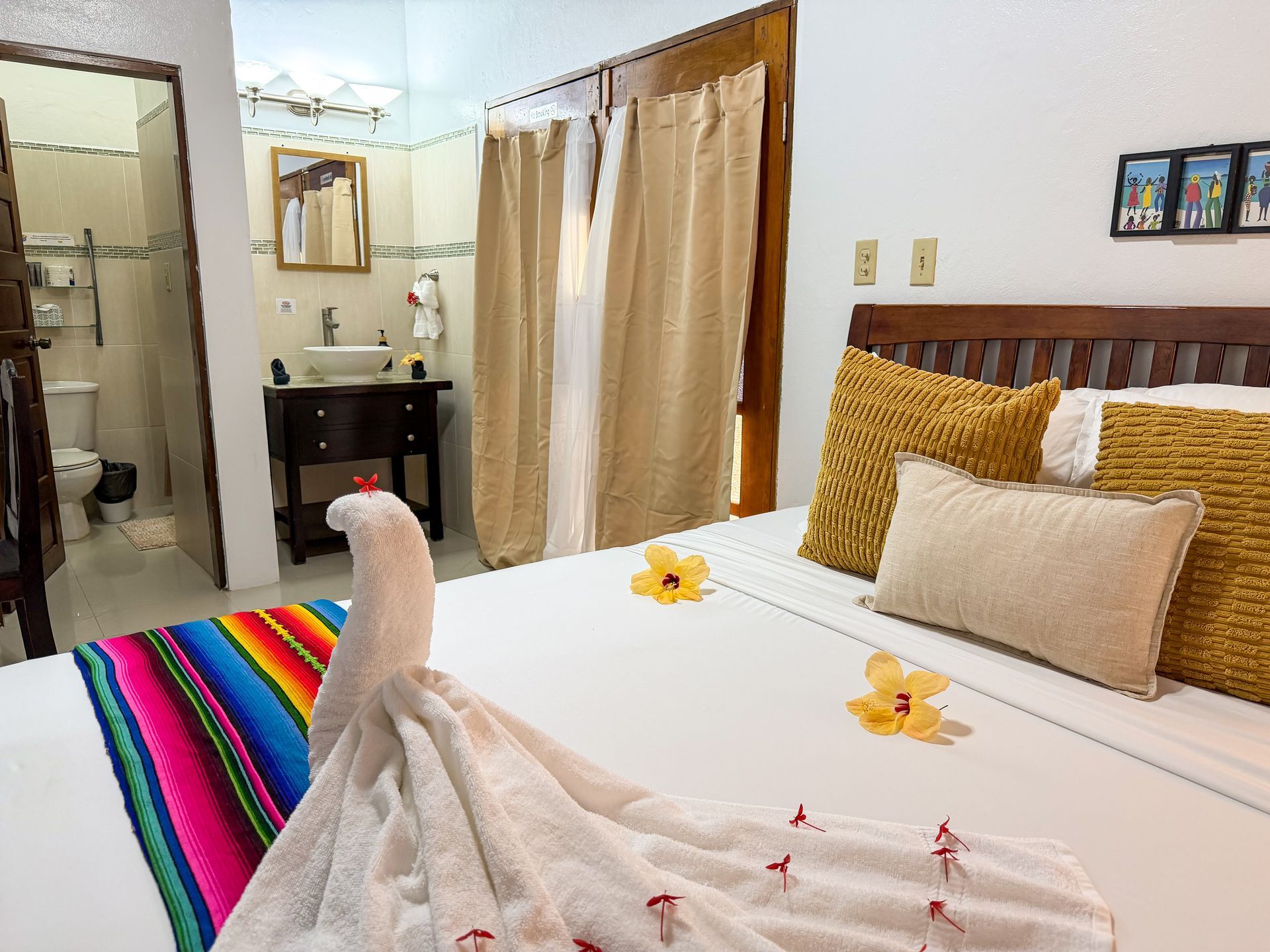 Cozy deluxe queen room with comfortable bedding at Caribbean Shores B&B in Hopkins, Belize
