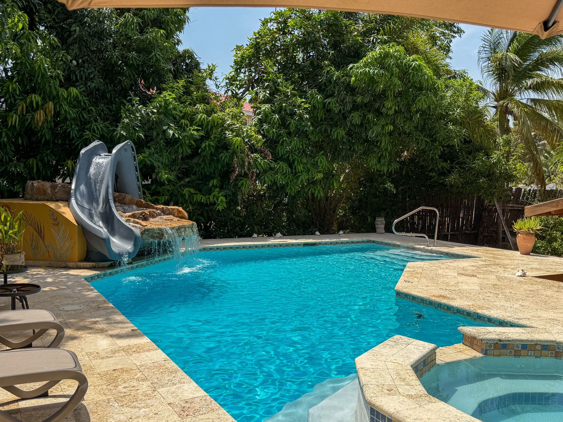 Swimming pool with waterfall feature at Caribbean Shores B&B in Hopkins Village Belize