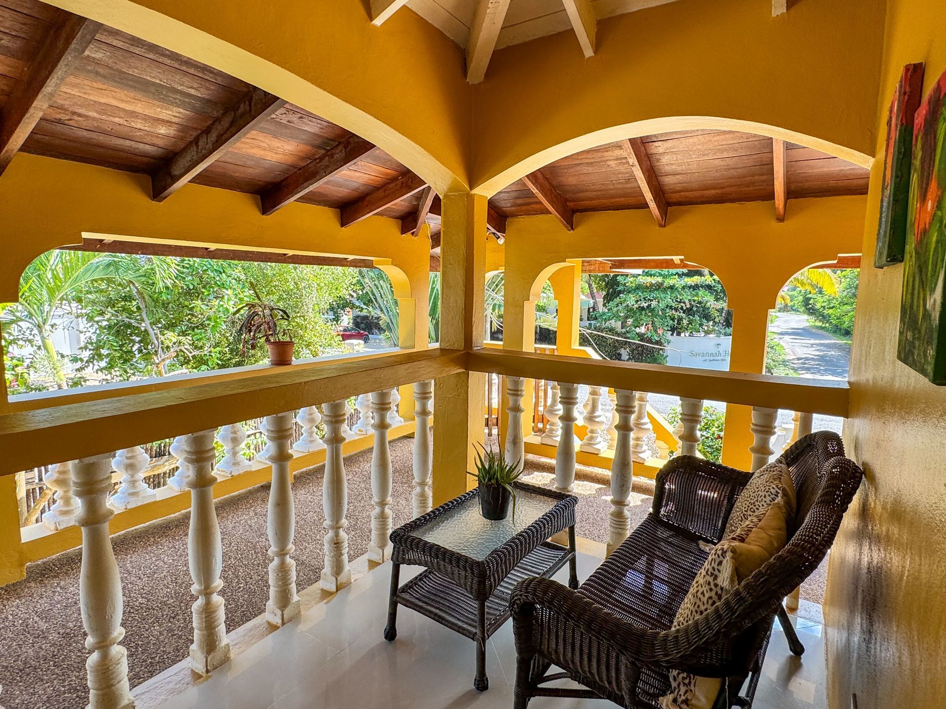A balcony with a couch and a table on it, room balcony at Caribbean Shores B&B, Hopkins Belize 