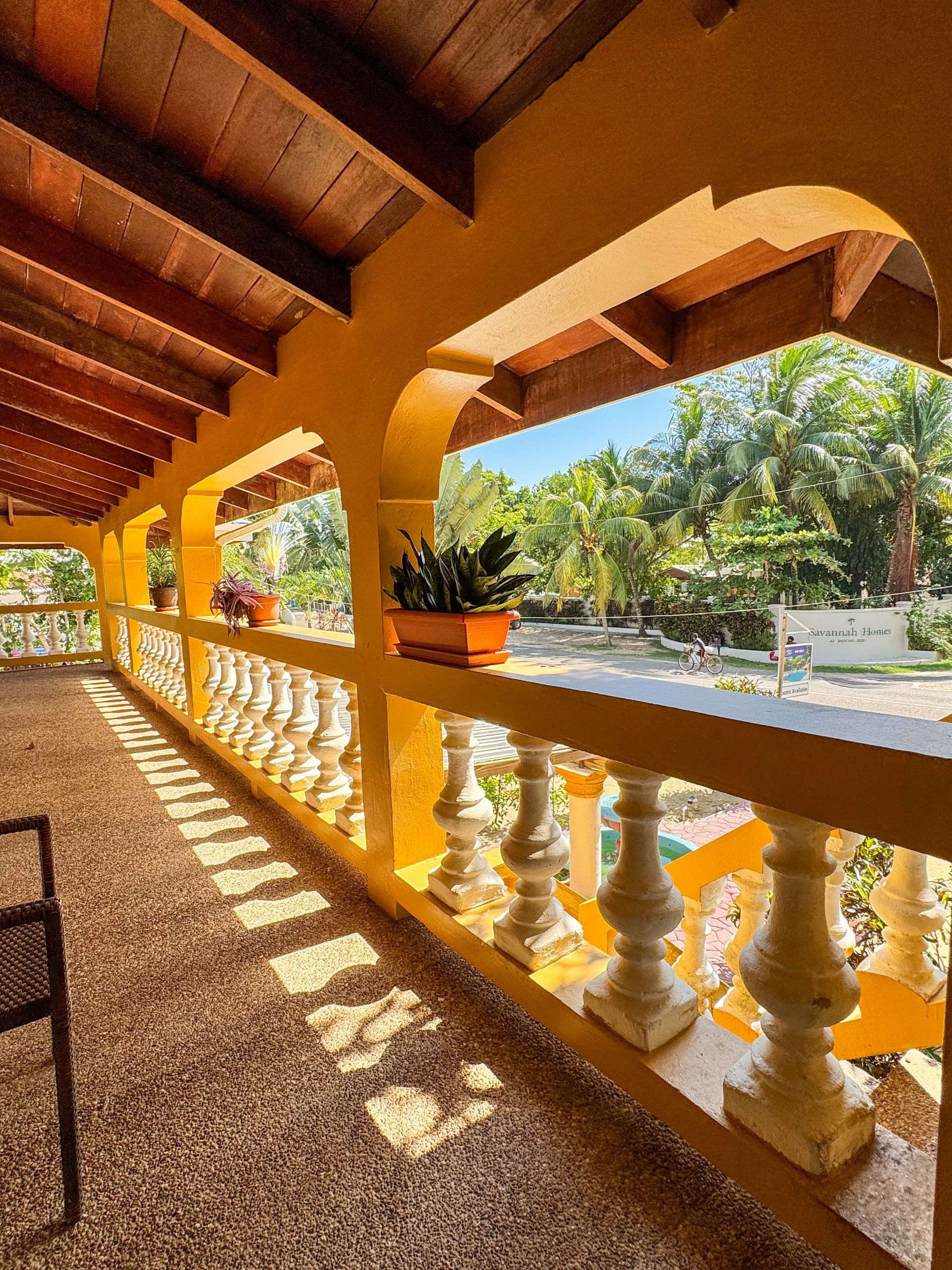 A balcony with a view of a lush green forest at Caribbean Shores B&B, Hopkins Belize