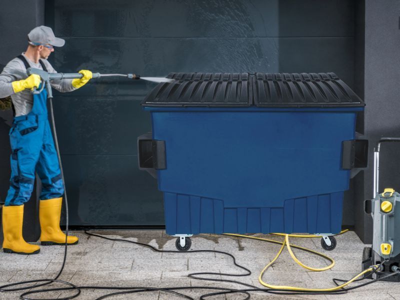 Man Cleaning a Dumpster