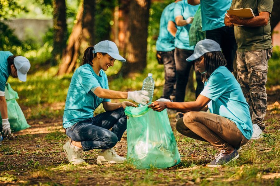 temporary staff putting bottle in trash bag