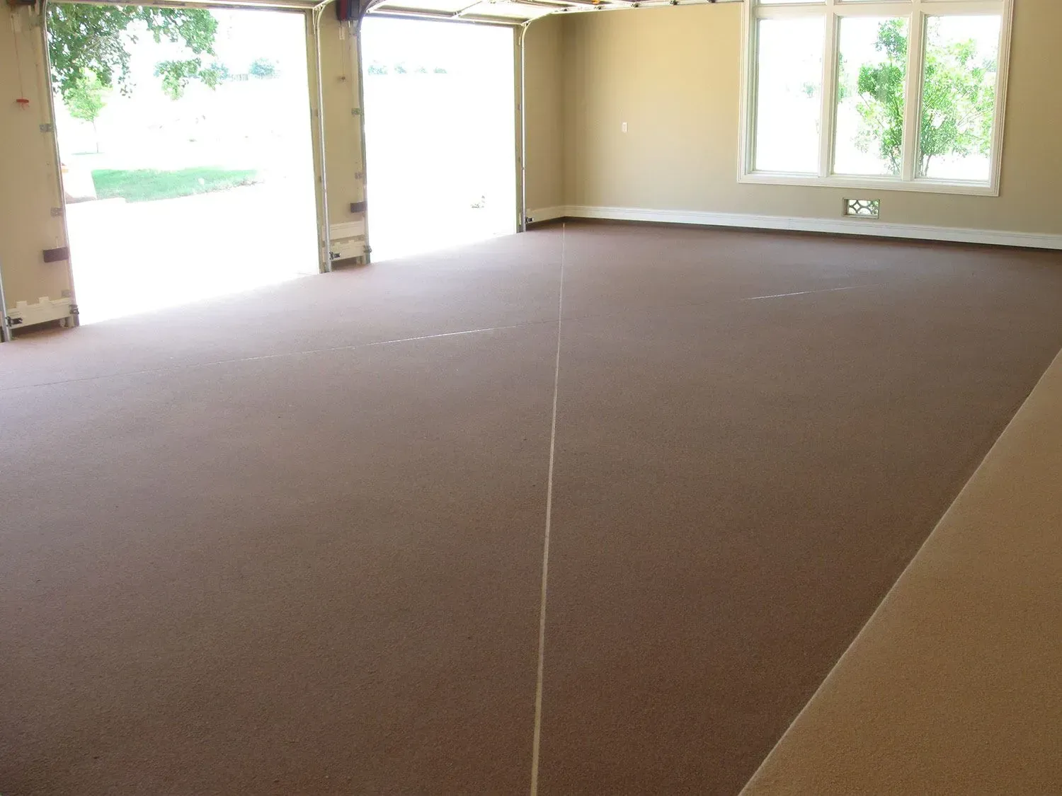 A large empty garage with a carpeted floor