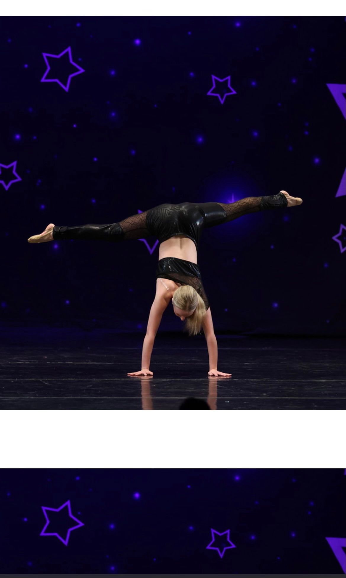 Contortionist balancing on one hand in a split pose on a dark stage with purple star lights