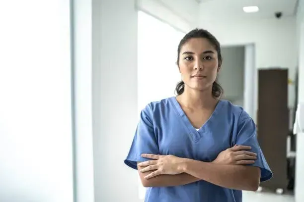 A home health aide waiting in a hospital to accompany patient home in NYC