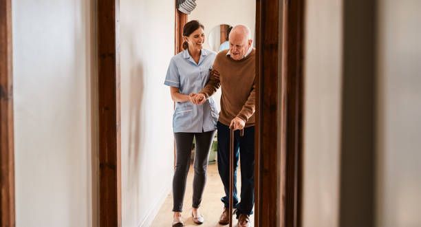 Home Health Aide assisting man at home post The Riverside Premier Rehabilitation & Healing Center 