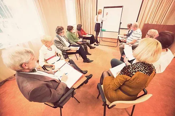 A group of people are sitting in a circle in a room.