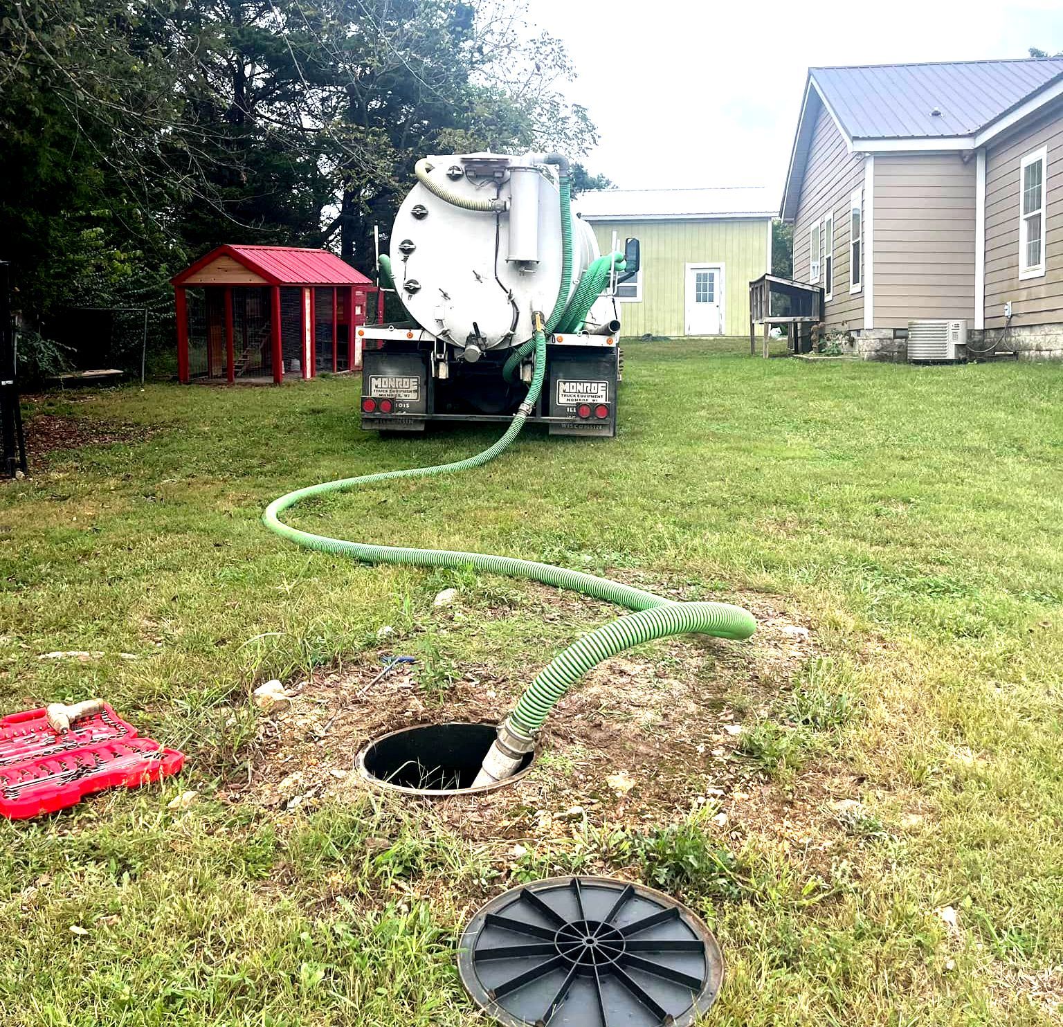 White truck providing septic tank pumping service at a home near Seymour and Rogersville, MO.