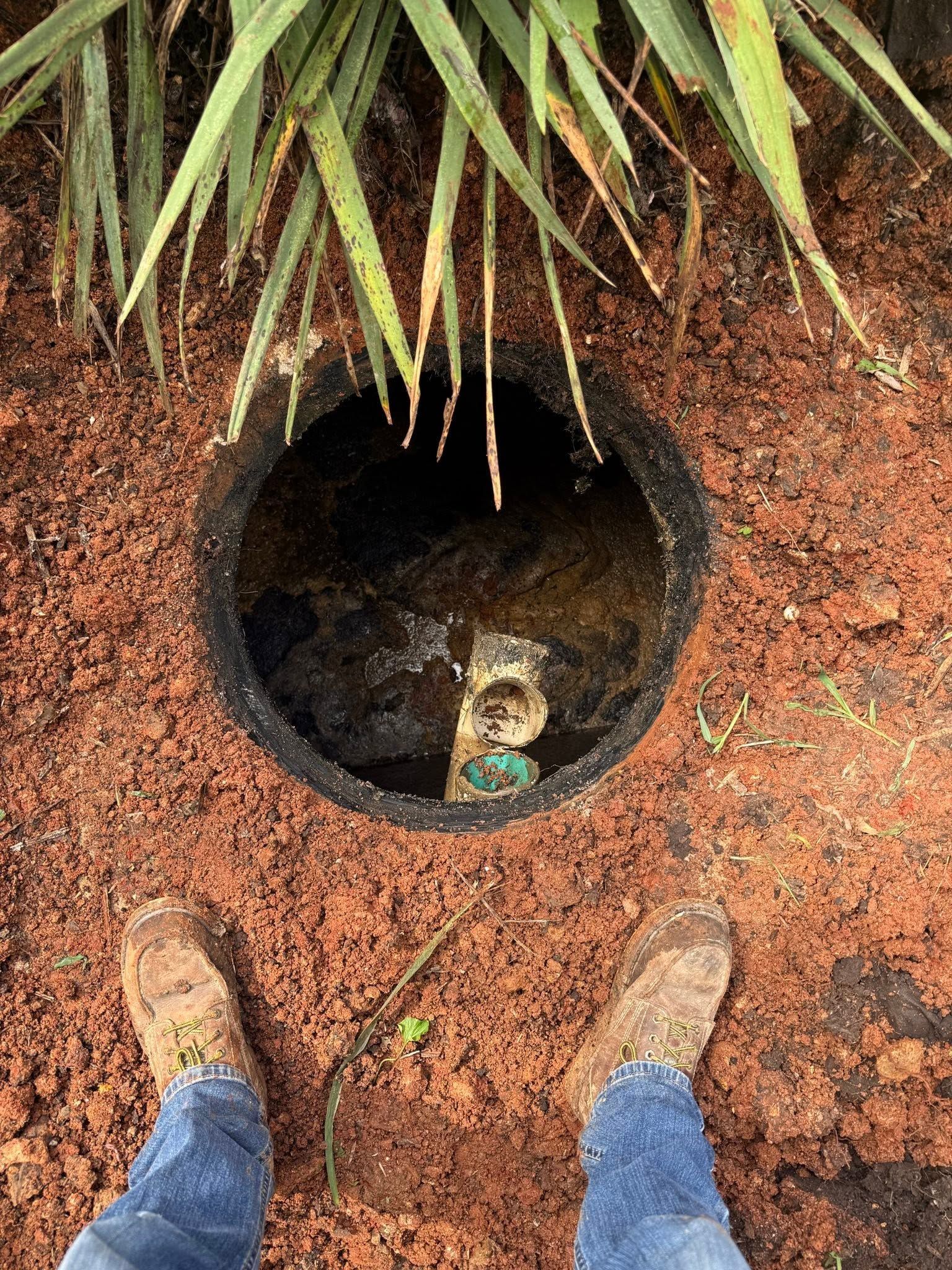 Open septic tank access during rural Missouri septic inspection before home purchase.