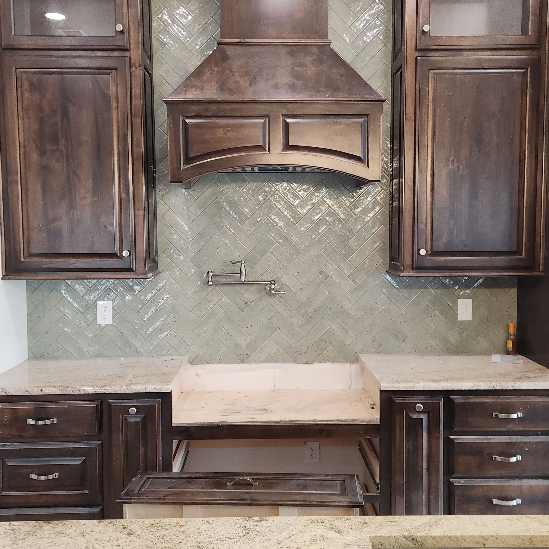 Modern bathroom with a glass shower, dark hexagon tile floor, and a doorway to another room. Modern bathroom with a glass shower, dark hexagon tile floor, and a doorway to another room.