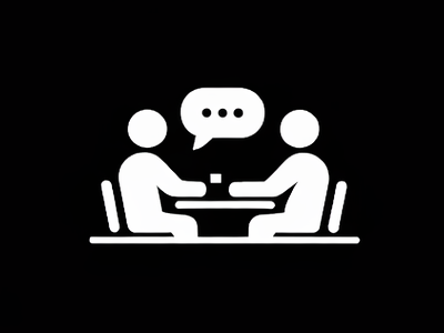 Two people seated across a table with a speech bubble above them, in white icon style on black background