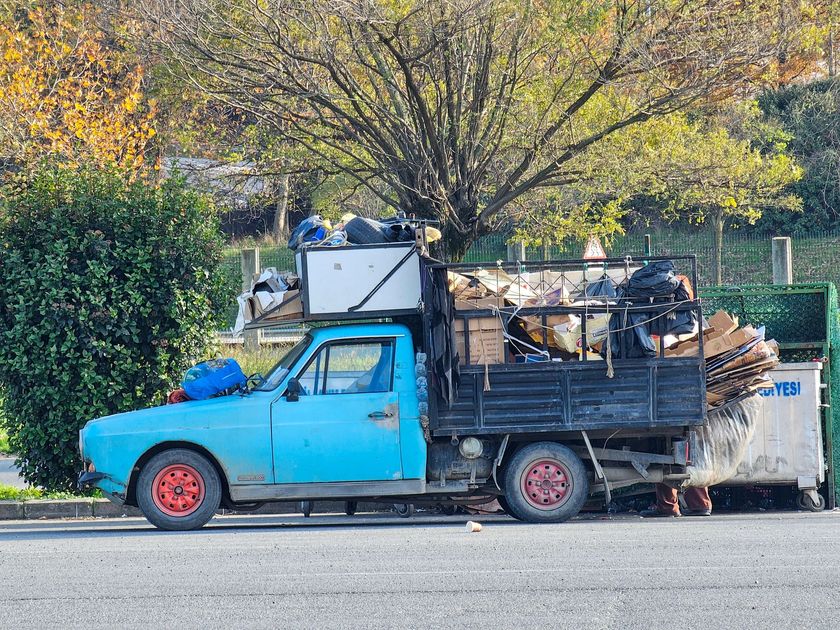 Kent Junk Removal services, WA crew loading trash bags into a garbage truck during neighborhood cleanup.