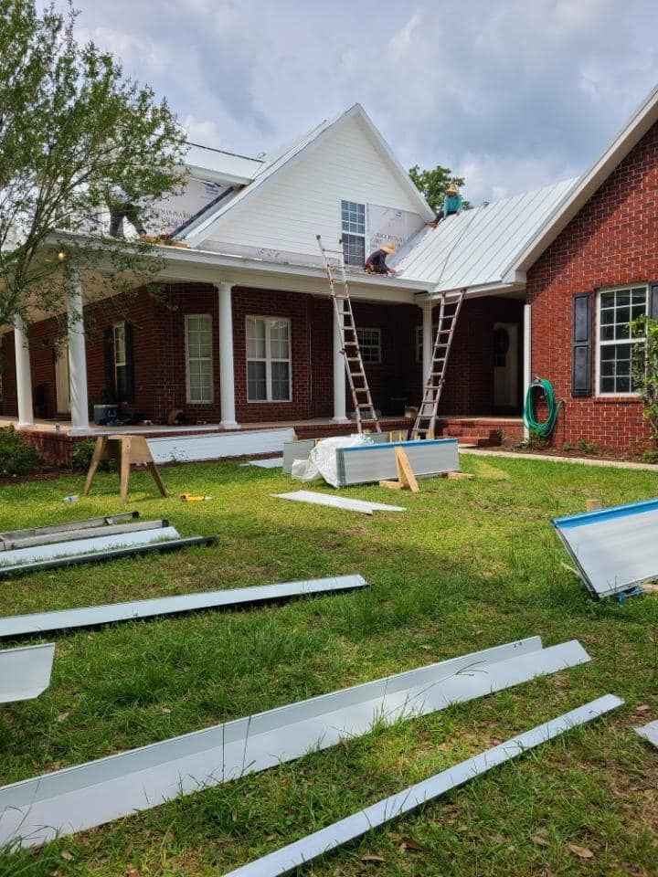 Man Working On The Roof Of A Brick House — Enterprise, AL — Waters Roofing LLC