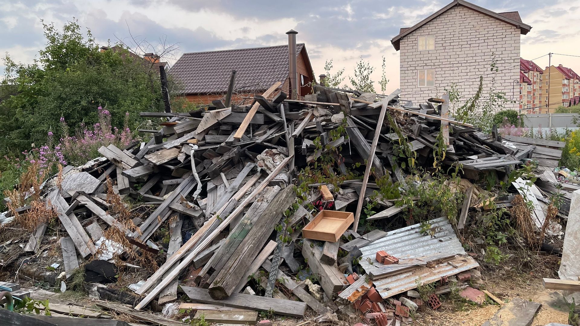 A Pile of Wood Is Sitting in Front of A House
