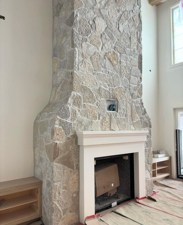 Floor-to-ceiling fireplace in Oakfield Webstone Eden natural stone